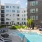 Large sparkling blue pool with a large pool deck and lounge chairs