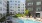 Large sparkling blue pool with a large pool deck and lounge chairs