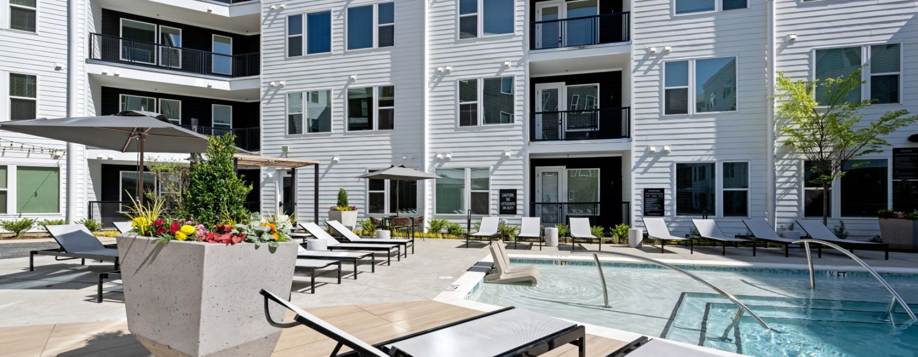 Close up of lounge chairs and landscaping on pool deck