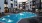 Large sparkling blue pool with a large pool deck and lounge chairs