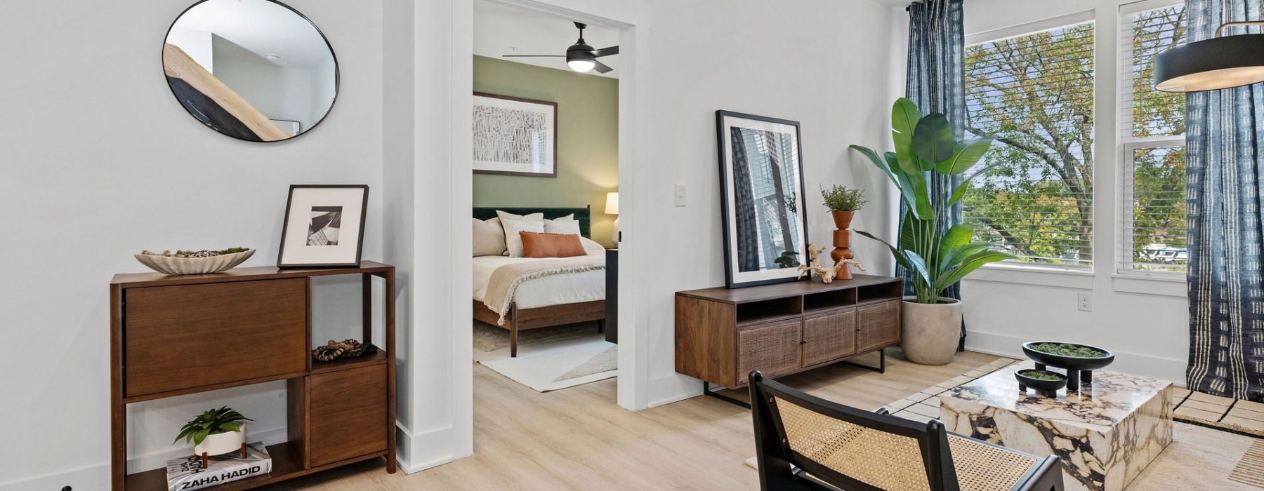 Apartment living area with a view into the bedroom